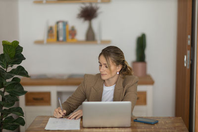 Woman working at home with laptop. home office.  notebook for working. 