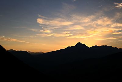 Scenic view of silhouette mountains against sky during sunset