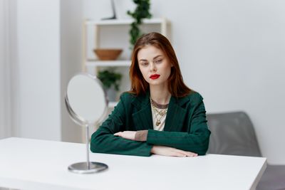 Portrait of young woman using laptop at home