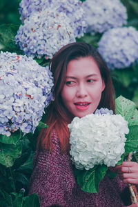 Smiling woman by flowering plants