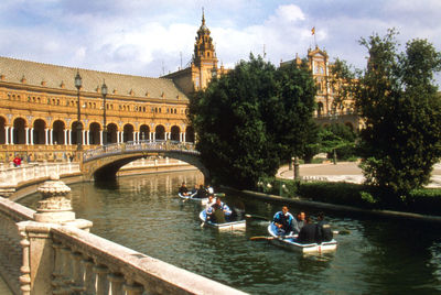 Boats in river with city in background