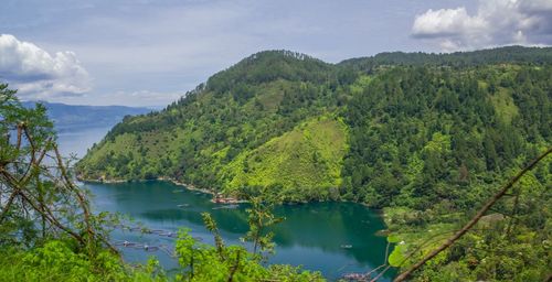 Scenic view of lake and mountains against sky