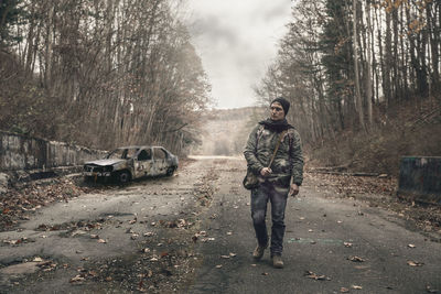 Full length of man standing in forest