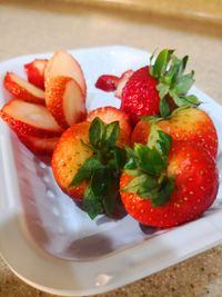 High angle view of strawberries in plate on table