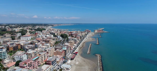 High angle view of sea and buildings against sky