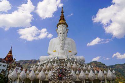 Panoramic view of statues outside building against sky