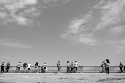 Group of people on the beach against sky