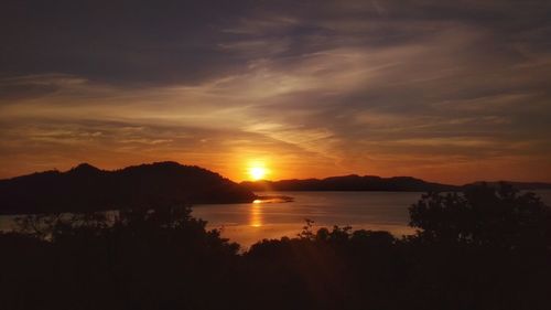 Scenic view of lake against orange sky