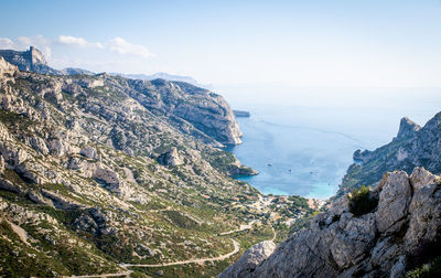 High angle view of rocky coastline against sky