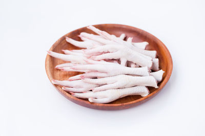 High angle view of bread in bowl against white background