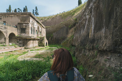 Rear view of woman standing against trees