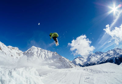 Low angle view of person snowboarding