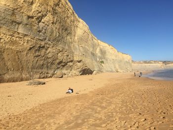 Scenic view of beach against clear sky