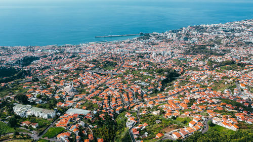 High angle view of townscape by sea