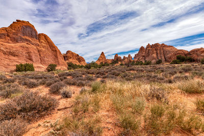 Rock formations on desert landscape with blue skies