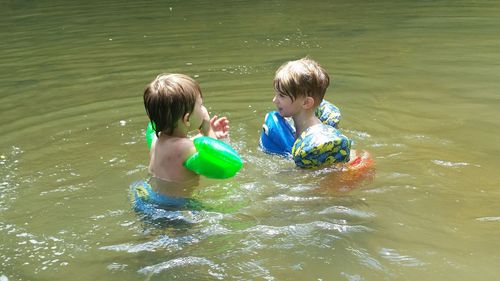 Boys swimming in river