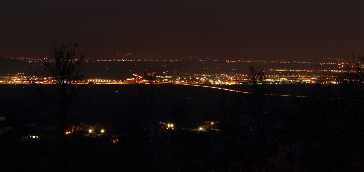 ILLUMINATED CITYSCAPE AT NIGHT