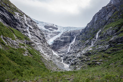 Scenic view of waterfall against sky