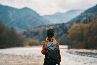 Rear view of man looking at mountains