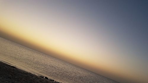 Scenic view of sea against clear sky during sunset