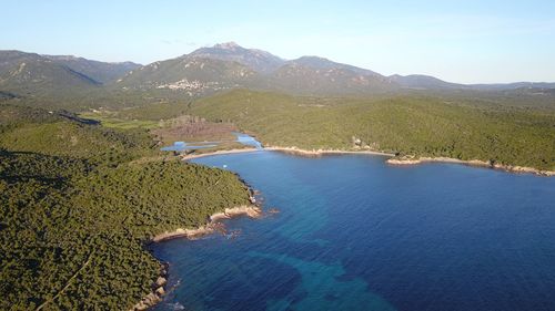 High angle view of sea and mountains against sky