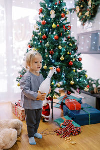 Portrait of siblings playing christmas tree