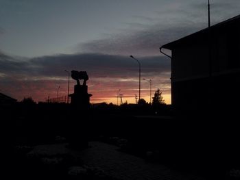 Silhouette built structure against sky at sunset