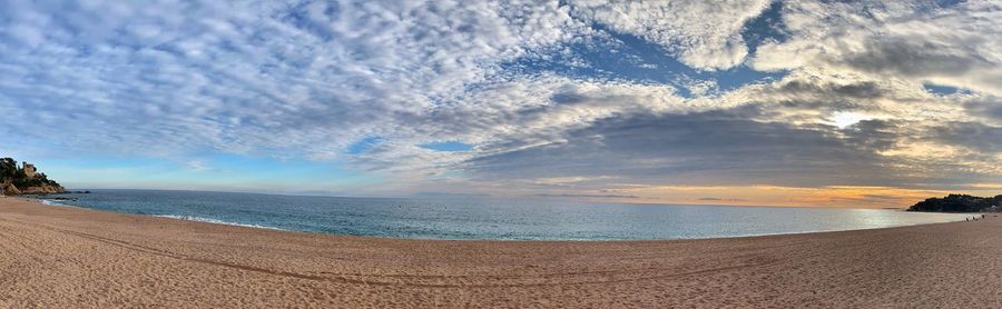 Scenic view of beach against sky during sunset