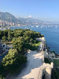 High angle view of city by sea against sky