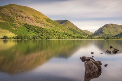 Scenic view of lake and mountains against sky