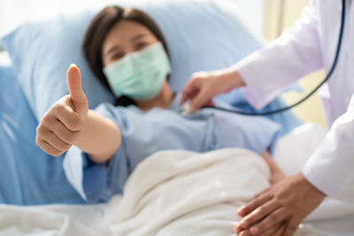 Midsection of man lying on bed