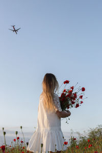 Low angle view of women against sky