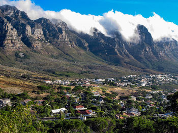 High angle view of townscape and mountains against sky