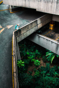 High angle view of man sitting on bridge