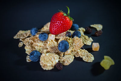 Close-up of strawberries on table against black background