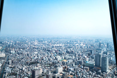 High angle view of modern buildings in city against clear sky