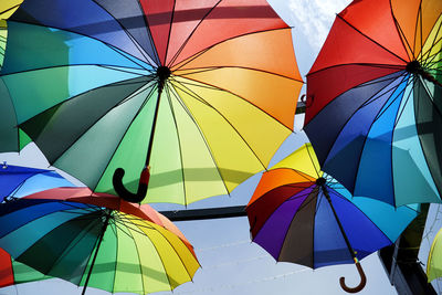 Low angle view of multi colored umbrella against sky