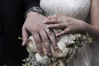 Midsection of couple holding hands
