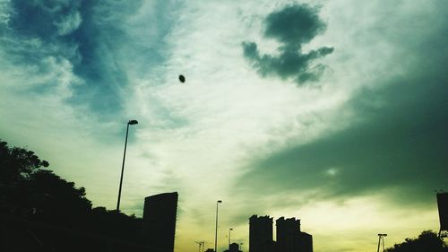 Low angle view of building against cloudy sky