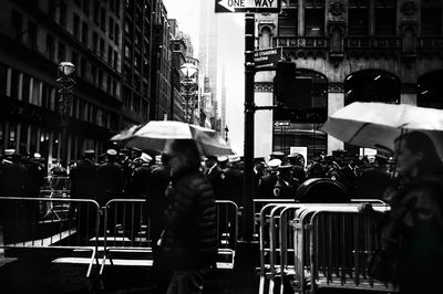 People walking on wet street in city