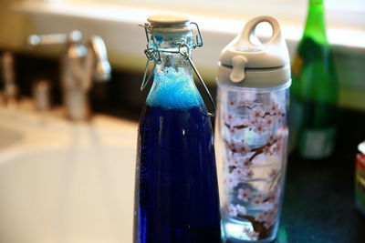 Close-up of wine bottles on table