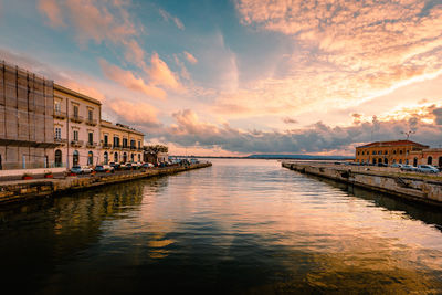 Scenic view of river against sky during sunset