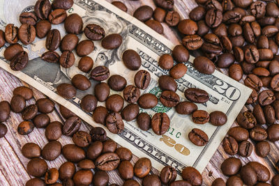 Coffee beans lie on top of a banknote