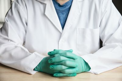 Midsection of scientist working in laboratory