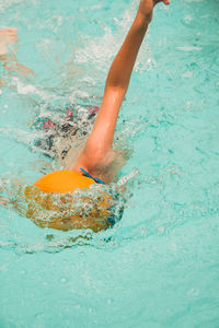 Low section of woman swimming in pool