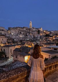 Rear view of woman looking at cityscape