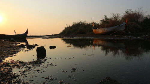 Scenic view of lake against sky during sunset
