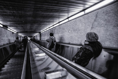 Rear view of people on escalators