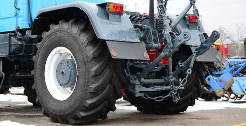 Close-up of a machinery on road in city