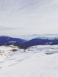 Scenic view of snow covered mountains against sky